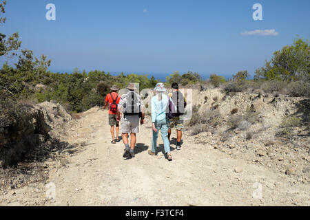 Walkers walking with backpacks on a path near the Kaplica Coast in North Cyprus  KATHY DEWITT Stock Photo