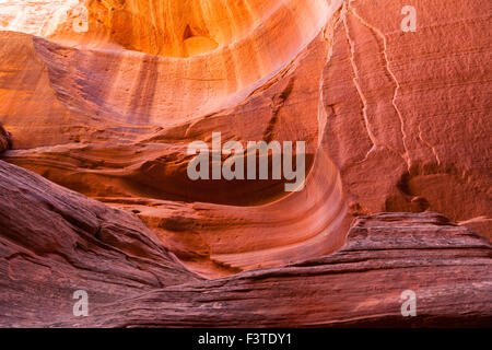 The eroded sandstone walls of Canyon X in Page Arizona with variegated color layers. Stock Photo