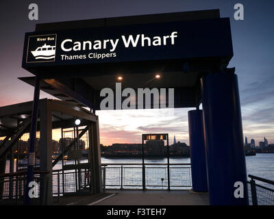 Pier embarkation point for Thames Clipper River boats, Columbia Wharf Shard & City buildings behind, Canary Wharf London UK Stock Photo