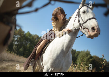 Beautiful girl riding a horse Stock Photo
