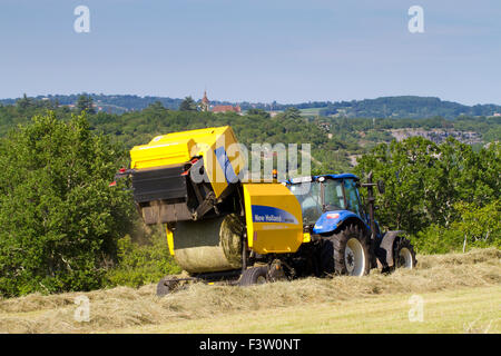 Contractor with a New Holland T5.95 tractor and a New Holland BR7060 round baler baling hay. Near Rocamadour, Lot, France. May. Stock Photo