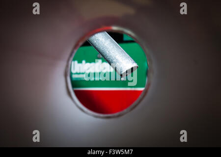 A simulated view from inside a car's petrol tank of fuel dripping from an unleaded petrol pump nozzle. Stock Photo