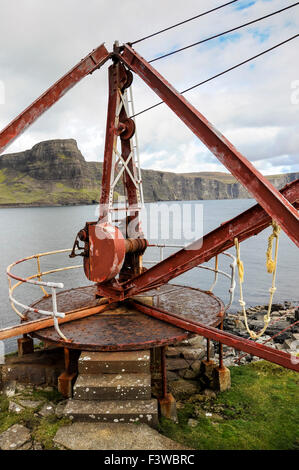 Old crane at Neist point on the Isle of Skye with Waterstein Head behind. Stock Photo