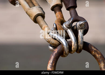 Close up of rusty old shackle lock with open shackle and key next to it ...