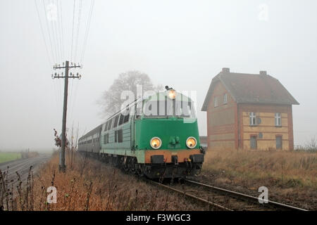 Passenger train passing through countryside Stock Photo