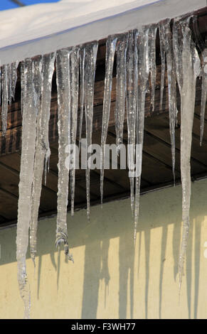 Icicles drooping from the roof Stock Photo