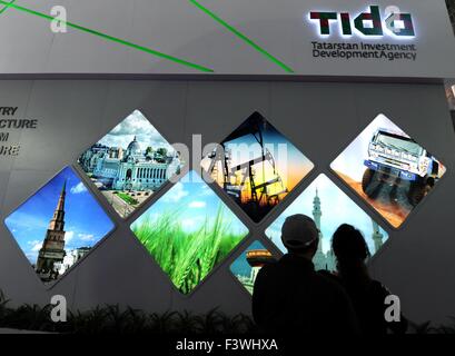 (151013) -- HARBIN, Oct. 13, 2015 (Xinhua) -- Two citizens look at the booth of Russian republic of Tatarstan during the second China-Russia Exposition in Harbin, northeast China's Heilongjiang Province, Oct. 13, 2015. Nearly 10,000 businessmen from 103 countries and regions attended the expo. The event will last till Oct. 16, 2015. (Xinhua/Wang Song)  (zhs) Stock Photo