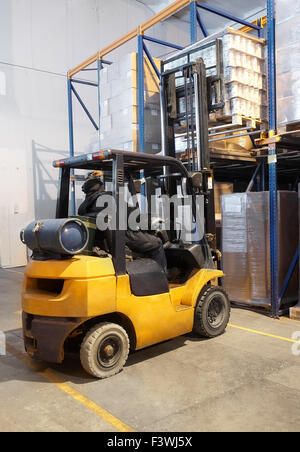 forklift loader stacking in warehouse Stock Photo