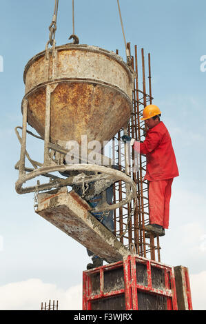construction workers pouring concrete in form Stock Photo
