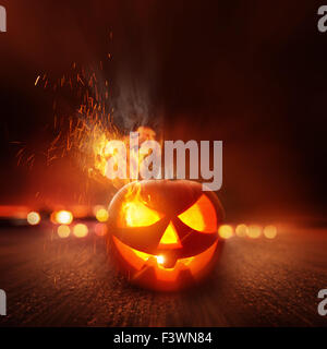 Spooky Halloween Night. A scary Jack O Lantern lit up on Halloween. Stock Photo