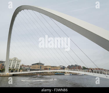 Jet skier passing under the Gateshead Millennium Bridge on the River Tyne Stock Photo