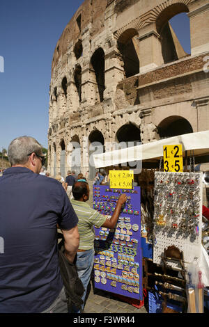 Tourists at souvenir stall at the Colosseum or Flavian Amphitheatre, Rome, Italy. Stock Photo