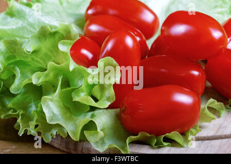 Small tomatoes and salad leaves close up Stock Photo