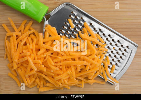 https://l450v.alamy.com/450v/f3wy9e/close-view-of-cheese-that-has-been-grated-with-a-cheese-grater-atop-f3wy9e.jpg
