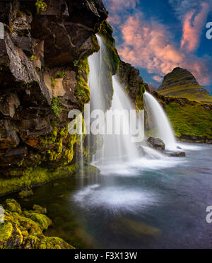 Kirkjufellsfoss on the Snæfellsnes Penisula. Kirkjufellsfoss is an iconic photographic landmark in Iceland. Close to the town of Grundarfjordur. Stock Photo