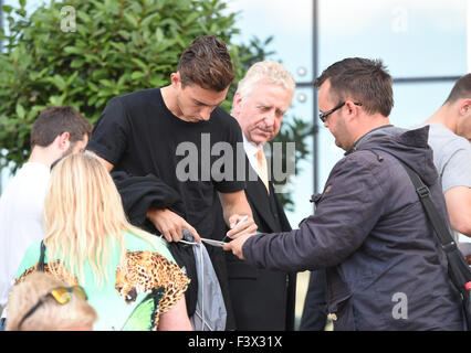 Matteo Darmian and Morgan Schneiderlin mobbed by fans as they arrive back at their hotel after Training.  Featuring: Matteo Darmian Where: Manchester, United Kingdom When: 12 Aug 2015 Stock Photo