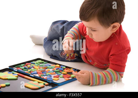 Boy plays with the magnetic designer Stock Photo