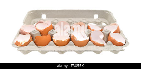 A dozen broken eggshells in an opened cardboard container on a white background. Stock Photo