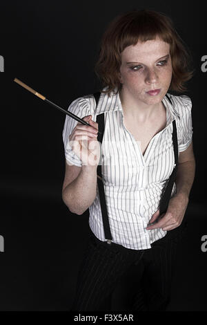Young red-haired woman on a black background Stock Photo