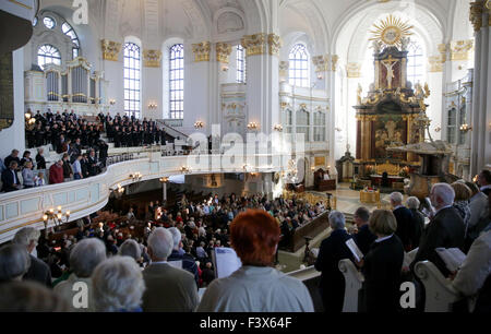 Visitors attend the bell ceremony at the St. Michael's Church in Hamburg, Germany, 27 September 2015. Nearly 100 years after eight bells of the St. Michael's Church were melted down during World War I, the bells will be complete again. The last two bells were consecrated and struck for the first time during the bell ceremony held on the same day. Photo: Axel Heimken/dpa Stock Photo