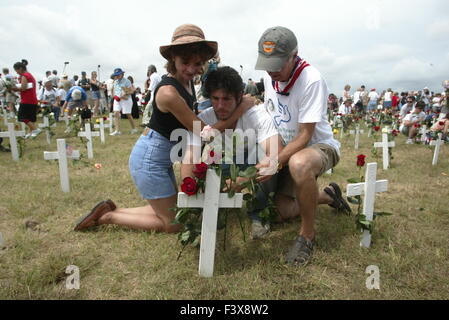 a man is overcome by emotion after placing a flower on a crosst at Camp Casey II Stock Photo