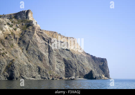 Mountain on a rocky coastline.View from sea. Stock Photo