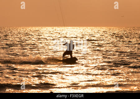 Kite surfer sailing in the sea Stock Photo