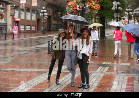 Young women celebrating the rain, Gastown Vancouver. Stock Photo