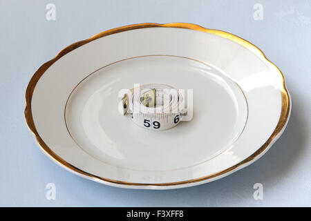 Roll of centimeter on chinaware Stock Photo