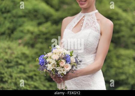 Wedding bouquet in bride's hands Stock Photo