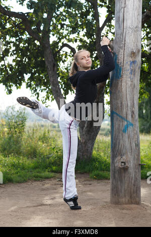 Young woman fitness exercises in city park Stock Photo