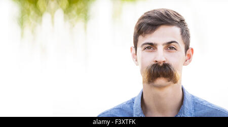 Young man with fake mustaches. Dental health concept. Stock Photo