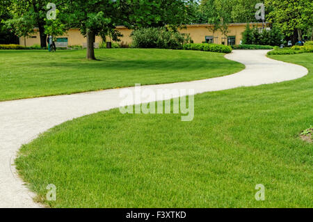 Winding path through a peaceful green garden Stock Photo