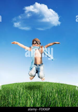 Happy kid jumping outdoors Stock Photo - Alamy