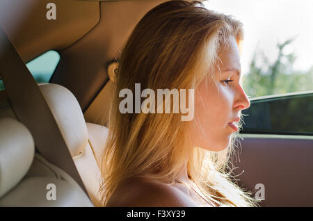 Dejected woman sitting in a car Stock Photo