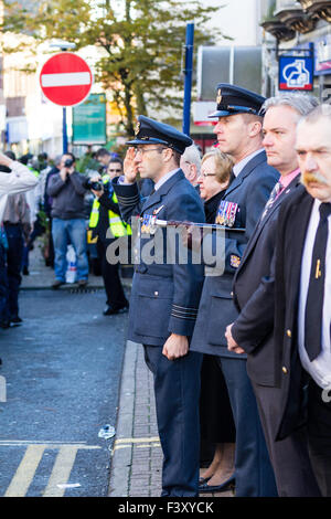 View along lines of senior officers standing saluting as a Remembrance Sunday parade marches past in the High Street of Ramsgate, England. Stock Photo