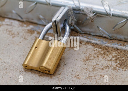 A padlock on an iron door - close-up Stock Photo