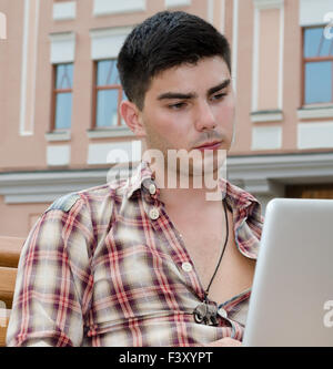 Young man using a laptop Stock Photo