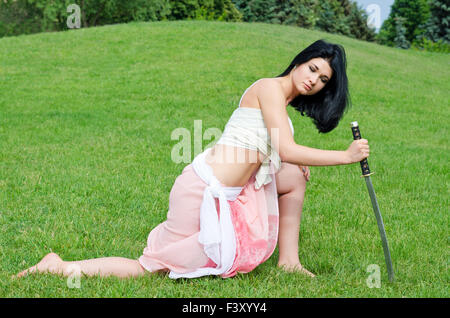Woman posing with a sword Stock Photo