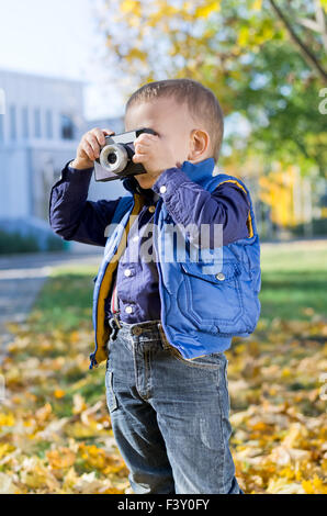 Cute little boy with retro camera Stock Photo