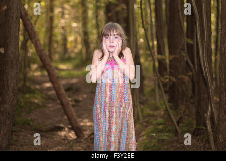 Lost little girl in the forest. Stock Photo