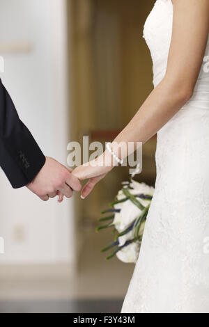 Bride and groom holding hands Stock Photo