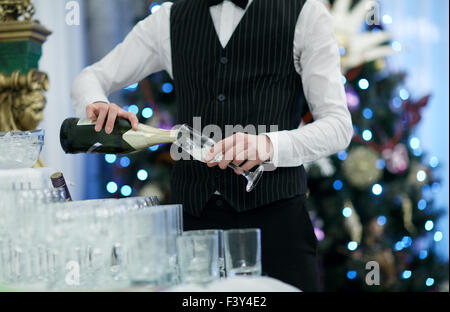 Waiter pouring glasses of champagne Stock Photo