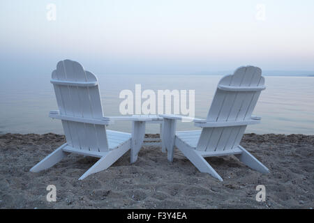 Empty wooden deck chairs on a beach Stock Photo