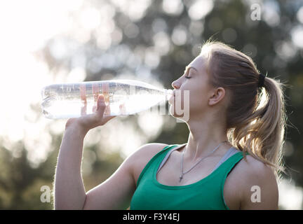 Young woman drinking water after fitness Stock Photo