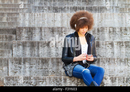 Young, black woman listening music Stock Photo