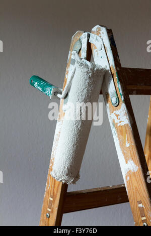 Painters roller on a ladder Stock Photo