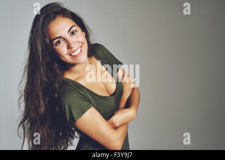 Portrait of happy young woman with long hair and trendy shirt Stock Photo