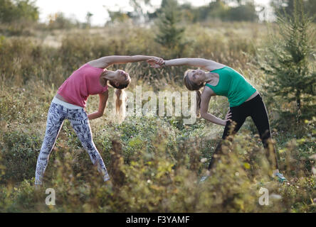 Two supple young women working out together Stock Photo