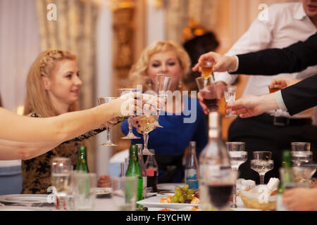 Friends raising their glasses in a toast Stock Photo
